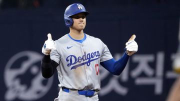 Los Angeles Dodgers designated hitter Shohei Ohtani gestures after hitting a single during the third inning of an opening day baseball game against the San Diego Padres at the Gocheok Sky Dome in Seoul, South Korea Wednesday, March 20, 2024, in Seoul, South Korea. (AP Photo/Ahn Young-joon)