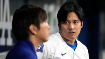 Los Angeles Dodgers' designated hitter Shohei Ohtani, right, chats with his interpreter Ippei Mizuhara during an exhibition baseball game between Team Korea and the Los Angeles Dodgers at the Gocheok Sky Dome in Seoul, South Korea, Monday, March 18, 2024. Ohtani’s interpreter and close friend has been fired by the Dodgers following allegations of illegal gambling and theft from the Japanese baseball star. (AP Photo/Lee Jin-man)