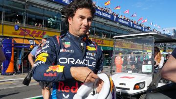 Red Bull driver Sergio Perez of Mexico walks down pit lane following his third place finish during the qualifying session for the Australian Formula One Grand Prix at Albert Park, in Melbourne, Australia, Saturday, March 23, 2024. (AP Photo/Asanka Brendon Ratnayake)