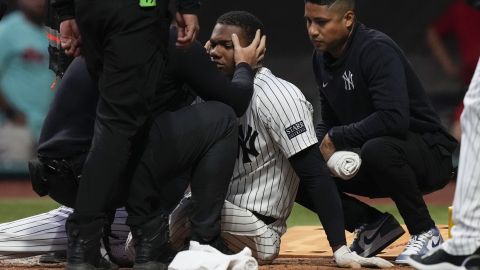 New York Yankees' Oscar Gonzalez, center, is attended to by team medical staff at the second inning during an exhibition baseball game against Diablos Rojos at Alfredo Harp Helu Stadium in Mexico City, Monday, March 25, 2024. (AP Photo/Fernando Llano)