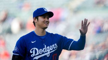Los Angeles Dodgers designated hitter Shohei Ohtani warms up before an exhibition baseball game against the Los Angeles Angels, Tuesday, March 26, 2024, in Anaheim, Calif. (AP Photo/Ryan Sun)