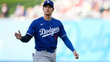 Los Angeles Dodgers designated hitter Shohei Ohtani warms up before an exhibition baseball game against the Los Angeles Angels, Tuesday, March 26, 2024, in Anaheim, Calif. (AP Photo/Ryan Sun)