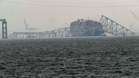 A container ship rests against the wreckage of the Francis Scott Key Bridge on Thursday, March 28, 2024, in Baltimore, Md. After days of searching through murky water for the workers missing after the bridge collapsed, officials are turning their attention Thursday to what promises to be a massive salvage operation. (AP Photo/Matt Rourke)