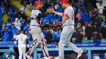 St. Louis Cardinals relief pitcher Giovanny Gallegos, right, and catcher Ivan Herrera celebrate the team's 6-5 win in the 10th inning of a baseball game against the Los Angeles Dodgers, Saturday, March 30, 2024, in Los Angeles. (AP Photo/Jae C. Hong)