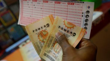 Duane Bouligny holds up Powerball tickets he purchased at Moza Easy Shop in San Francisco, Wednesday, Jan. 13, 2016. The Powerball jackpot for Wednesday night's drawing is at least $1.5 billion, the largest lottery jackpot in the world. (AP Photo/Jeff Chiu)
