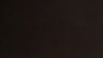 A woman walks past banners protesting against Walmart near the proposed site of a Walmart store in Chinatown on Thursday, Sept. 5, 2013, in Los Angeles. Walmart workers and supporters took part in a nationwide day of protests calling for better jobs and higher wages. (AP Photo/Jae C. Hong)