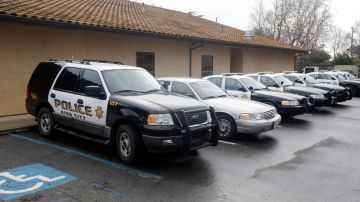 Patrol cars are lined up at the King City Police Deptment on Wednesday, Feb. 26, 2014, in King City, Calif. The acting police chief and two officers in King City were removed from duty after being arrested on suspicion of selling or giving away the impounded cars of poor residents, authorities said. (AP Photo/Marcio Jose Sanchez)