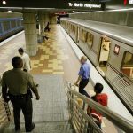 Los Angeles County Sheriff's Deputy Baron Howard, lower left, descends to the platform on the Los Angeles Metro subway's Hollywood and Vine Station during regular patrol Friday, March 12, 2004. Authorities around California said Friday they were being vigilant in guarding transportation systems after the bombings in Spain, and some commuters were on edge. The sheriff's department has been running drills to prepare for attacks on rail and bus lines. (AP Photo/Nick Ut)