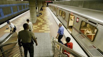Los Angeles County Sheriff's Deputy Baron Howard, lower left, descends to the platform on the Los Angeles Metro subway's Hollywood and Vine Station during regular patrol Friday, March 12, 2004. Authorities around California said Friday they were being vigilant in guarding transportation systems after the bombings in Spain, and some commuters were on edge. The sheriff's department has been running drills to prepare for attacks on rail and bus lines. (AP Photo/Nick Ut)