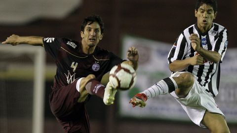 Argentina's Lanus' Hernan Grana, left, fights for the ball with Paraguay's Libertad's Rodolfo Gamarra during a Copa Libertadores soccer game in Buenos Aires, Tuesday, Feb. 9, 2010. (AP Photo/Natacha Pisarenko)