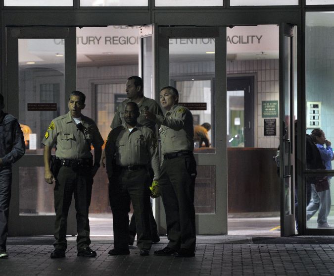 Los Angeles County sheriffs confer in front at the entrance of the Century Regional Detention Facility in Lynwood, Calif. before Lindsay Lohan is released early Monday, Aug. 02, 2010, in Lynwood, Calif. The actress began serving a probation violation sentence July 20. A judge sentenced Lohan last July 6, 2010 to 90 days in this facility. (AP Photo/Richard Hartog)