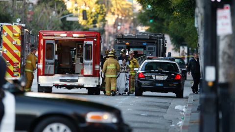 Los Angeles County Fire Department paramedics take into custody a man police say is a suspect in a fatal shooting and stand-off at an apartment building in the Hollywood section of Los Angeles, after hours of negotiations by the Los Angeles Police Department on Tuesday, Jan. 4, 2011. (AP Photo/Damian Dovarganes)