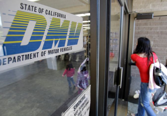 A customer walks into a Department of Motor Vehicles office in Redwood City, Calif., Thursday, June 30, 2011. All Californians with a vehicle will pay $12 more a year to register it and millions of property owners who live outside cities will pay $150 a year for state fire protection. Those are among the new fees included in the state budget passed late Tuesday night without any Republican support. (AP Photo/Paul Sakuma)