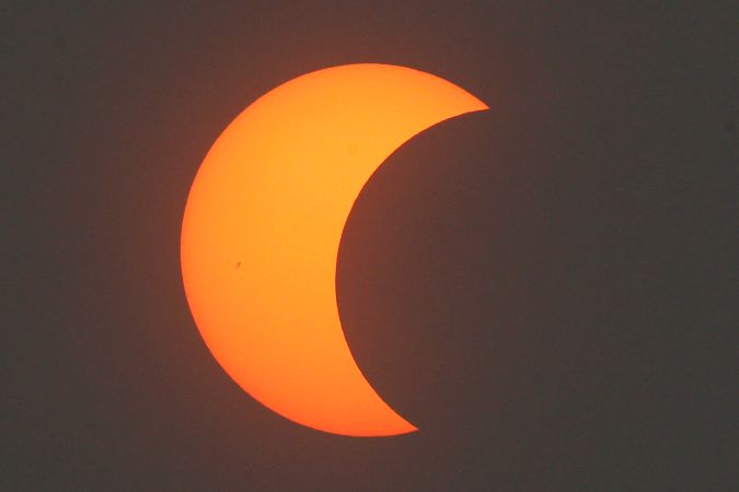 A partial annular solar eclipse is seen over Beijing, China, Monday, May 21, 2012. Millions of Asians watched as a rare "ring of fire" eclipse crossed their skies early Monday. The annular eclipse, in which the moon passes in front of the sun leaving only a golden ring around its edges, was visible to wide areas across the continent. (AP Photo/Ng Han Guan)