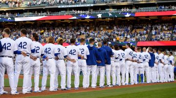 Members of the Los Angeles Dodgers line up for the national anthem as they wear No. 2 in honor of former Dodger Jackie Robinson prior to a baseball game against the San Francisco Giants, Friday, April 15, 2016, in Los Angeles. (AP Photo/Mark J. Terrill)