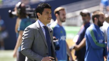 Seattle Sounders assistant coach Gonzalo Pineda, who was filling in for coach Brian Schmetzer, walks on the pitch before the team's exhibition soccer match against Eintracht Frankfurt, Saturday, July 8, 2017, in Seattle. (AP Photo/Ted S. Warren)