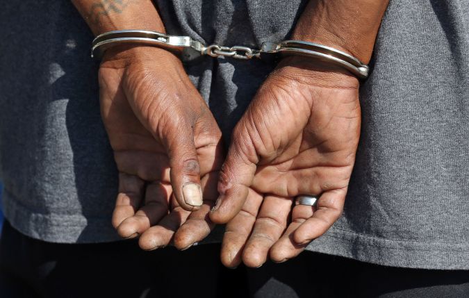 A man is handcuffed during a crackdown on crime near an overcrowded downtown homeless shelter plagued by drugs and violence Monday, Aug. 14, 2017, In Salt Lake City. The area has long been a hotbed of criminal activity but recently made headlines with a string of violent crimes, capturing the attention of House Speaker Greg Hughes and Utah Gov. Gary Herbert. (AP Photo/Rick Bowmer)