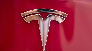 FILE - This Wednesday, Aug. 8, 2018, file photo shows the Tesla emblem on the back end of a Model S in the Tesla showroom in Santa Monica, Calif. The California Highway Patrol says it may have used the Autopilot system of a Tesla Model S to stop the car after its driver fell asleep early Friday, Nov. 30, 2018, in the San Francisco suburb of Redwood City. (AP Photo/Richard Vogel, File)