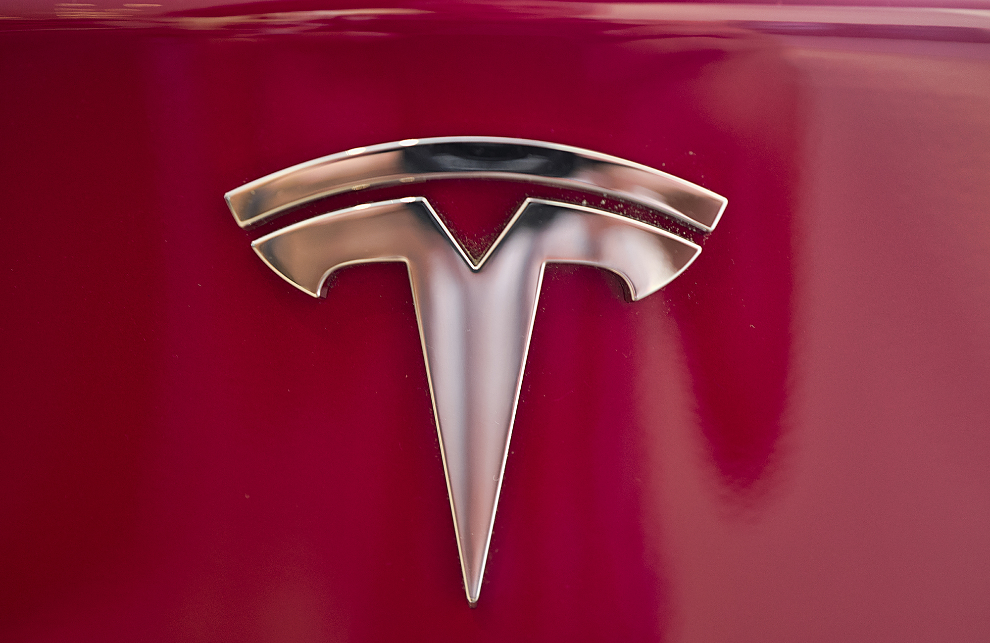 FILE - This Wednesday, Aug. 8, 2018, file photo shows the Tesla emblem on the back end of a Model S in the Tesla showroom in Santa Monica, Calif. The California Highway Patrol says it may have used the Autopilot system of a Tesla Model S to stop the car after its driver fell asleep early Friday, Nov. 30, 2018, in the San Francisco suburb of Redwood City. (AP Photo/Richard Vogel, File)
