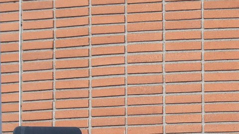 A security guard stands at the entrance of the Etz Jacob Congregation/Ohel Chana High School building Friday, Feb. 15, 2019, in Los Angeles. Police arrested a security guard on suspicion of shooting a self-described First Amendment activist after the two engaged in a videotaped confrontation outside a Los Angeles synagogue and school. (AP Photo/Marcio Jose Sanchez)