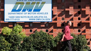 A man passes a California Department of Motor Vehicles office in the Arleta neighborhood of Los Angeles Tuesday, April 9, 2019. (AP Photo/Richard Vogel)