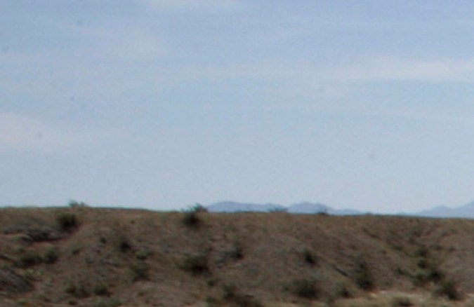 FILE - This March 11, 2009 file photo shows an antenna to send data stands on a rise above an earthquake monitoring well, right, powered by a solar electric panel, lower left, as scientists from the U.S. Geological Survey set up an earthquake monitoring station on the San Andreas Fault in a desert canyon near Thermal, Calif. The nation's first statewide quake warning system will debut Thursday, Oct. 17, 2019, coinciding with the 30th anniversary of the Loma Prieta earthquake that ravaged the San Francisco Bay area on Oct. 17, 1989, as well as the annual Great Shakeout safety drill. (AP Photo/Reed Saxon, File)