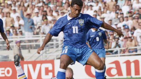 FILE - In this file photo dated July 13, 1994, Swedish goalie Thomas Ravelli watches Brazilian forward Romario dribble past him as Romario shoots at the goal during the World Cup soccer championship semifinal, Sweden vs. Brazil at the Rose Bowl in Pasadena, USA. The kick was saved on the line by Swedish defender Patrick Andersson (not in picture). The extrovert Sweden goalkeeper Ravelli who helped give the Scandinavian nation one of its greatest sporting rushes when the Sweden team reached the semifinals of the 1994 World Cup in the United States, and Sweden's national TV broadcaster plans Friday April 10, 2020, to replay the team's games over the coming weeks in an attempt to unite the nation during the coronavirus pandemic. (AP Photo/Thomas Kienzle, FILE)