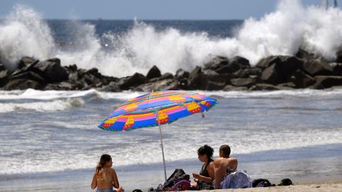 Beachgoers sit on Venice Beach during the coronavirus outbreak, Wednesday, May 13, 2020, in Los Angeles. Los Angeles County reopened its beaches Wednesday in the latest cautious easing of coronavirus restrictions that have closed most California public spaces and businesses for nearly two months. (AP Photo/Mark J. Terrill)