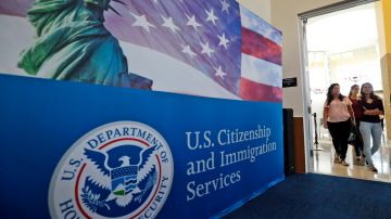 FILE - In this Aug. 17, 2018, file photo, people arrive before the start of a naturalization ceremony at the U.S. Citizenship and Immigration Services Miami Field Office in Miami. USCIS, The cash-strapped federal agency that oversees that nation's legal immigration system, scrapped plans Tuesday, Aug. 25, 2020, to furlough 13,000 employees, or nearly 70% of its workforce. The agency said it would maintain operations through September when the the fiscal year ends. (AP Photo/Wilfredo Lee, File)