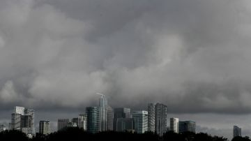 Grey clouds hang over the financial district of the City of London, Friday, Aug. 28, 2020. (AP Photo/Kirsty Wigglesworth)