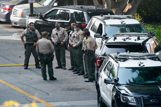 FILE - Police officers stand outside St. Francis Medical Center on Sept. 14, 2020, in Lynwood, Calif. after two Los Angeles County Sheriff's deputies were shot in an apparent ambush. Recent shootings of police officers and protests that have left scores of officers injured are stark reminders of the dangers facing law enforcement around a country grappling with police killings of African Americans.(AP Photo/Ashley Landis, File)
