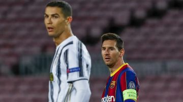 Barcelona's Lionel Messi, left, and Juventus' Cristiano Ronaldo during the Champions League group G soccer match between FC Barcelona and Juventus at the Camp Nou stadium in Barcelona, Spain, Tuesday, Dec. 8, 2020. (AP Photo/Joan Monfort)