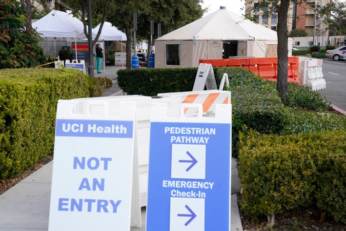 Medical tents are set up outside the emergency room at UCI Medical Center Thursday, Dec 17, 2020, in Irvine, Calif. California health authorities reported Thursday a record 379 coronavirus deaths and more than 52,000 new confirmed cases. (AP Photo/Ashley Landis)