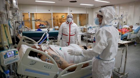 Dr. Elena Candia, right, and Nurse Felix Soto, attend a COVID-19 patient in the UCI of the General Hospital in Luque, Paraguay, Friday, June 11, 2021. According to Paraguay's Health Ministry, the country has surpassed 10,000 COVID-19 related deaths this week. (AP Photo/Jorge Saenz)