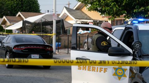 A Los Angeles County Sheriff's official guards a post at the scene after three young children were found dead in a bedroom at a residence in East Los Angeles, Monday, June 28, 2021. (AP Photo/Ringo H.W. Chiu)