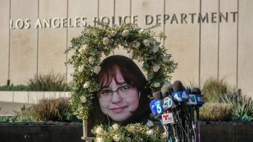 A wreath with a picture of Valentina Orellana-Peralta, is displayed at a news conference outside Los Angeles Police Department Headquaters in Los Angeles, Tuesday, Dec. 28, 2021. The parents of Valentina Orellana-Peralta -- the 14-year-old girl killed by a stray bullet fired by an LAPD officer at a North Hollywood clothing store last week, and their attorneys held a news conference to discuss the family's demand for transparency from the Los Angeles Police Department. (AP Photo/Ringo H.W. Chiu)