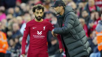 Liverpool's manager Jurgen Klopp, right, gives instructions to Liverpool's Mohamed Salah during the English Premier League soccer match between Liverpool and Manchester City at Anfield stadium in Liverpool, Sunday, Oct. 16, 2022. (AP Photo/Jon Super)