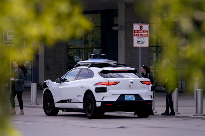 A Waymo self-driving vehicle sits curbside, Friday, Dec. 16, 2022, at the Sky Harbor International Airport Sky Train facility in Phoenix. Phoenix Mayor Kate Gallego announced Friday that Sky Harbor will be the first airport to have self-driving, ride-hailing service Waymo available. A test group has been using Waymo vehicles from the airport's sky train to downtown Phoenix since early November.(AP Photo/Matt York)
