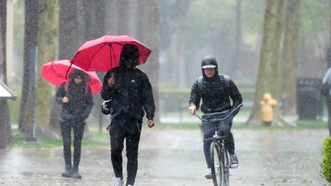 Rain falls on pedestrians on the University of Southern California campus on Tuesday, March 21, 2023, in Los Angeles. (AP Photo/Marcio Jose Sanchez)