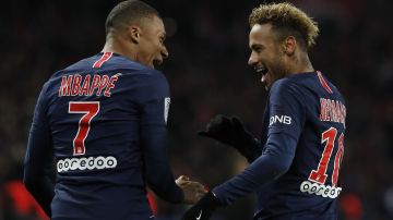 FILE - PSG's Kylian Mbappe, left, reacts with PSG's Neymar, celebrating after he scored his side's second goal during the League One soccer match between Paris Saint-Germain and Lille at the Parc des Princes stadium in Paris, Friday, Nov. 2, 2018. Mbappe has told Paris Saint-Germain he will leave the club at the end of the season, it was reported on Thursday, Feb. 15, 2024. (AP Photo/Thibault Camus, File)
