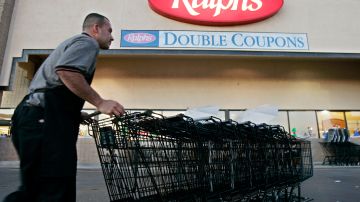 FILE -Francisco Luna collects shopping carts outside of a Ralphs grocery store in Los Angeles on Monday, Dec. 5, 2005. California sued the Ralphs supermarket chain on Thursday, Ded. 21, 2023, alleging that it violated state law by asking job-seekers whether they had criminal records and illegally rejecting hundreds of applicants (AP Photo/Kevork Djansezian, File)