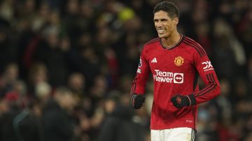 Manchester United's Raphael Varane celebrates on the full time during the English Premier League soccer match between Manchester United and Aston Villa at the Old Trafford stadium in Manchester, England, Tuesday, Dec. 26, 2023. Manchester United won 3-2. (AP Photo/Dave Thompson)