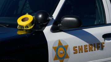 FILE - A roll of police tape is left on the windshield of a Los Angeles County sheriff's vehicle in the parking lot of its training academy in Whittier, Calif., Nov. 16, 2022. The Los Angeles County Sheriff’s Department released body camera footage on Friday, Dec. 29, showing a fatal shooting of a 27-year-old Black woman who had called to report domestic violence in early December. (AP Photo/Jae C. Hong, File)