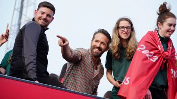 FILE - Wrexham co-owner Ryan Reynolds, center, celebrates with members of the Wrexham FC soccer team the promotion to the Football League in Wrexham, Wales, on May 2, 2023. Hollywood stars Ryan Reynolds and Rob McElhenney are three years into their unlikely ownership of Welsh soccer club Wrexham and their enthusiasm is far from fading. “Deadpool” star Reynolds sends text messages to players after games, posts on social media after the team's games and says his love for Wrexham is “indescribable.” (AP Photo/Jon Super, File)