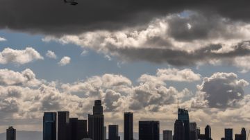 Clouds move over the Los Angeles skyline, Thursday, Feb. 8, 2024. Skies have cleared over most of California after days of wind, rain and heavy snowfall that caused power outages, street flooding and damaging mudslides. (AP Photo/Damian Dovarganes)