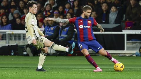 Granada's Jose Callejon, left, tries to block a shot by Barcelona's Inigo Martinez during the Spanish La Liga soccer match between Barcelona and Granada at the Olimpic Lluis Companys stadium in Barcelona, Spain, Sunday, Feb. 11, 2024. (AP Photo/Joan Monfort)