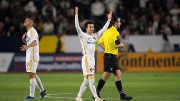 Los Angeles Galaxy midfielder Riqui Puig (10) and forward Dejan Joveljić (9) after a goal by Joveljić's goal during the second half of an MLS soccer match against the Inter Miami, Sunday, Feb. 25, 2024, in Carson, Calif. (AP Photo/Kyusung Gong)