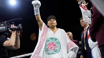 Isaac Cruz, of Mexico, celebrates before fighting Rolando Romero in a super lightweight title bout Saturday, March 30, 2024, in Las Vegas. (AP Photo/John Locher)