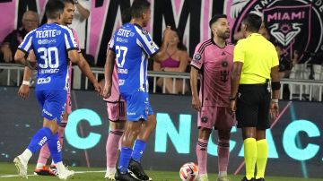 Inter Miami defender Jordi Alba, second from right, argues a call with an official during the first half of the team's CONCACAF Champions Cup quarterfinal soccer match against Monterrey, Wednesday, April 3, 2024, in Fort Lauderdale, Fla. Alba was given a yellow card on the play. (AP Photo/Lynne Sladky)