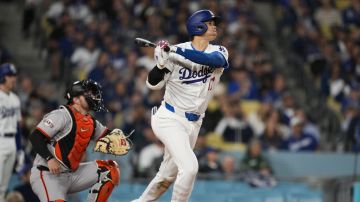 Los Angeles Dodgers designated hitter Shohei Ohtani hits a home run during the seventh inning of a baseball game against the San Francisco Giants in Los Angeles, Wednesday, April 3, 2024. (AP Photo/Ashley Landis)